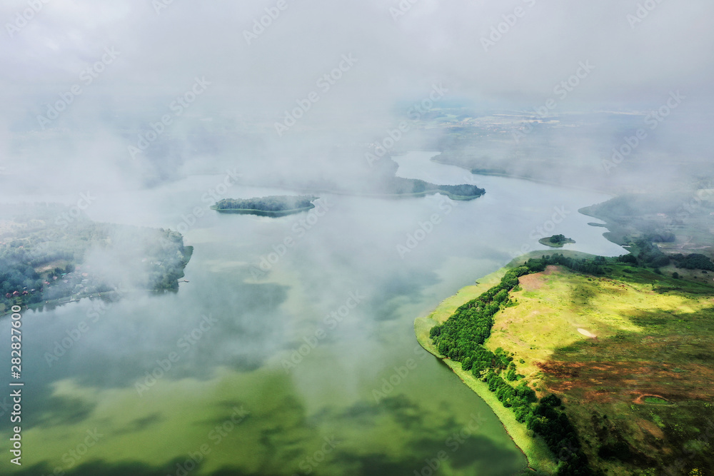 flight in the clouds over Lake Wadąg in Warmia in Poland flight in the clouds over Lake Wadąg in Warmia in Poland
