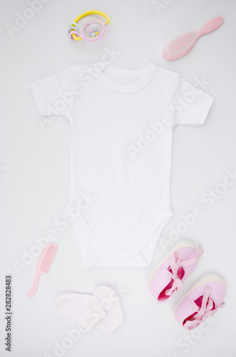 Flat lay baby clothes with white background