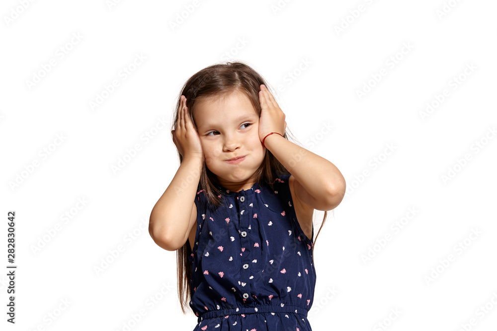 Close-up studio shot of beautiful brunette little girl posing isolated on white studio background. Close-up studio shot of beautiful brunette little girl posing isolated on white studio background.