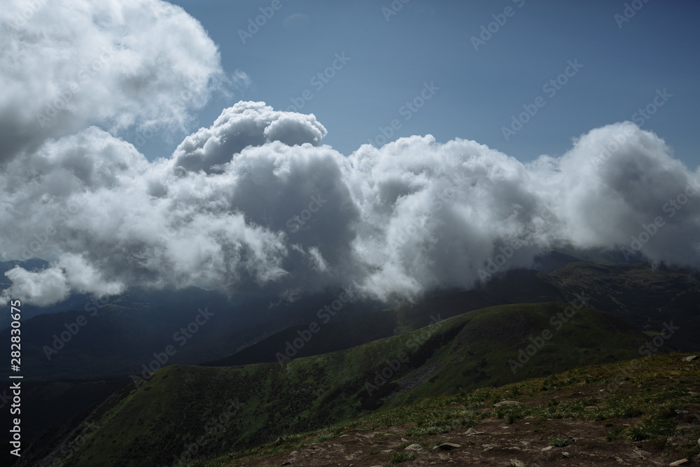 view from the top of the mountain to the old-fashioned mountains and beautiful clouds