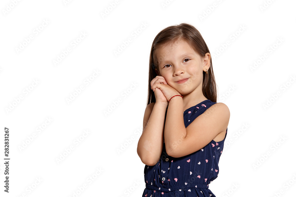 Close-up studio shot of beautiful brunette little girl posing isolated on white studio background. Close-up studio shot of beautiful brunette little girl posing isolated on white studio background.