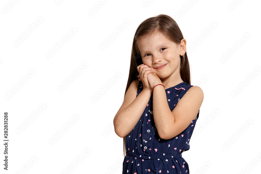 Close-up studio shot of beautiful brunette little girl posing isolated on white studio background. Close-up studio shot of beautiful brunette little girl posing isolated on white studio background.