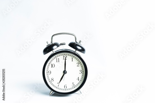 Black alarm clock isolated on white