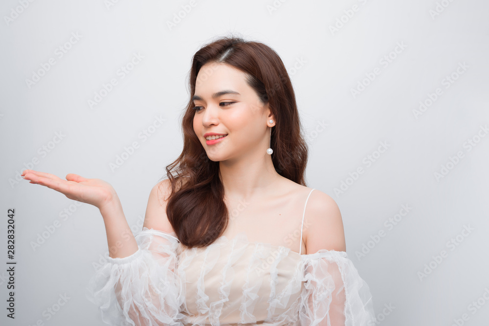 Body skincare care beauty Asian woman showing product on side with open hand Body skincare care beauty Asian woman showing product on side with open hand
