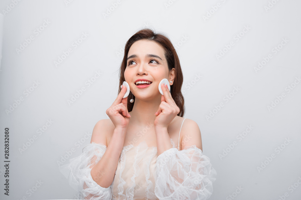 Beautiful young smiling woman with clean cotton pads . Facial treatment. Beauty skin care famale face . Expressive facial expressions. Beautiful young smiling woman with clean cotton pads . Facial treatment. Beauty skin care famale face . Expressive facial expressions.