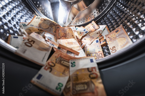 money laundering concept - euro banknotes in washing mashine