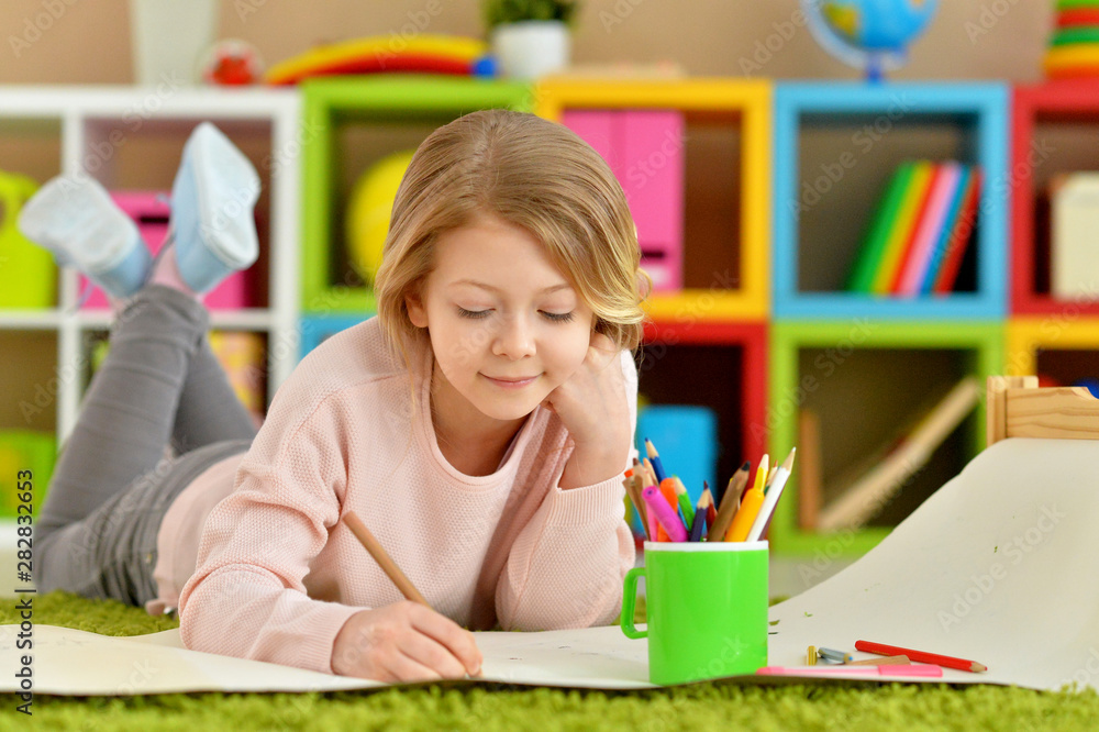 Portrait of cute smiling girl drawing at home Portrait of cute smiling girl drawing at home