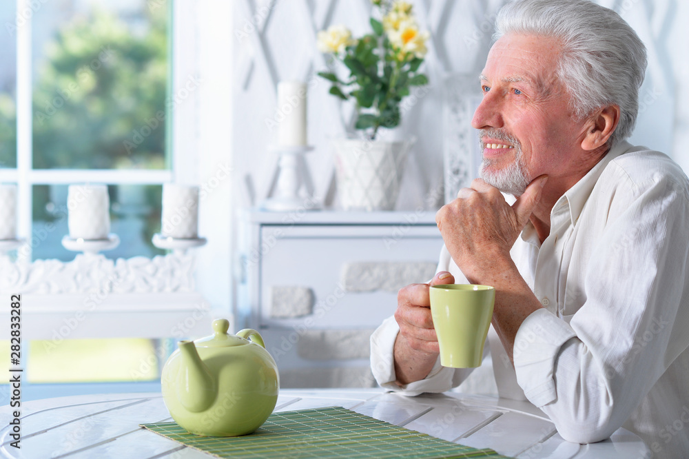 Portrait of senior man drinking tea at home Portrait of senior man drinking tea at home