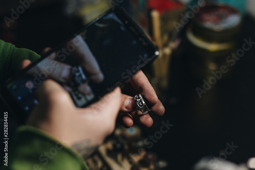 Jeweler taking picture of a ring
