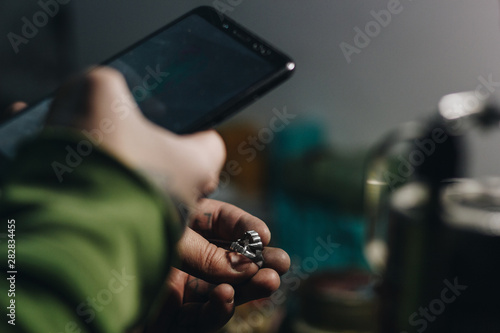 Jeweler taking picture of a ring © Iryna