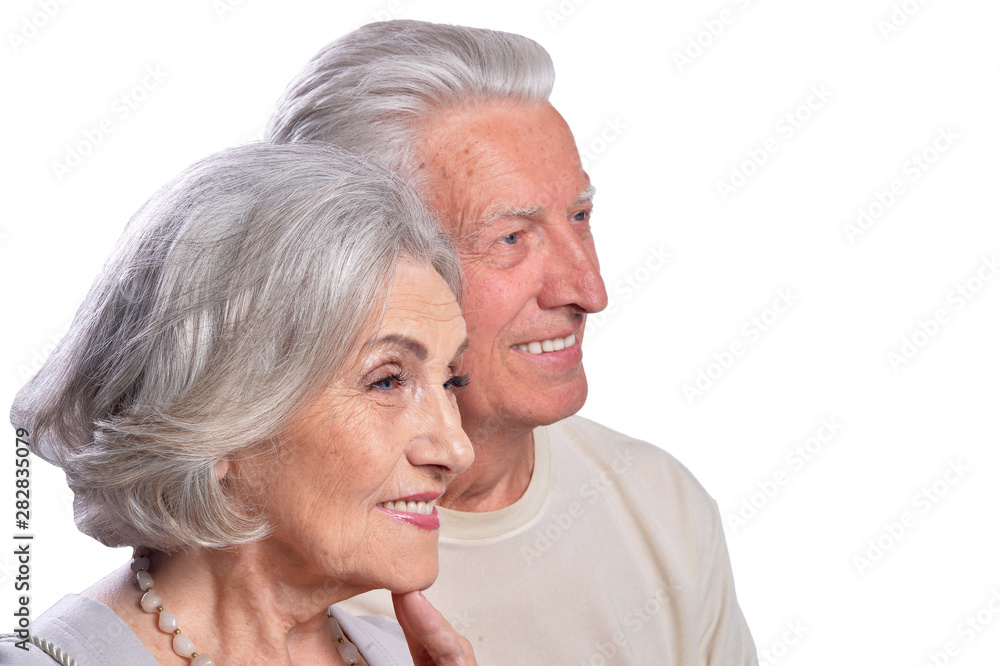 Happy senior couple embracing and posing on white background