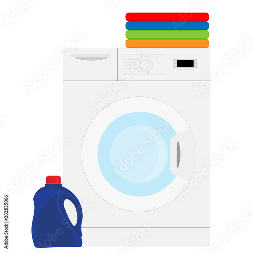 Laundry washing machine. Stack of colorful folded clothes.