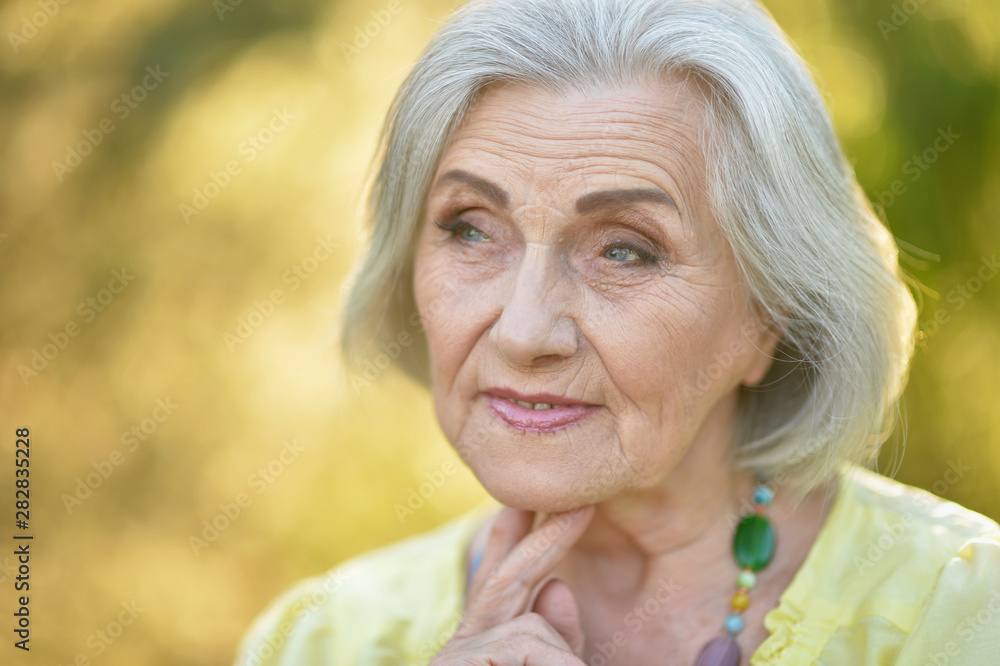 Portrait of sad senior beautiful woman in spring park Portrait of sad senior beautiful woman in spring park