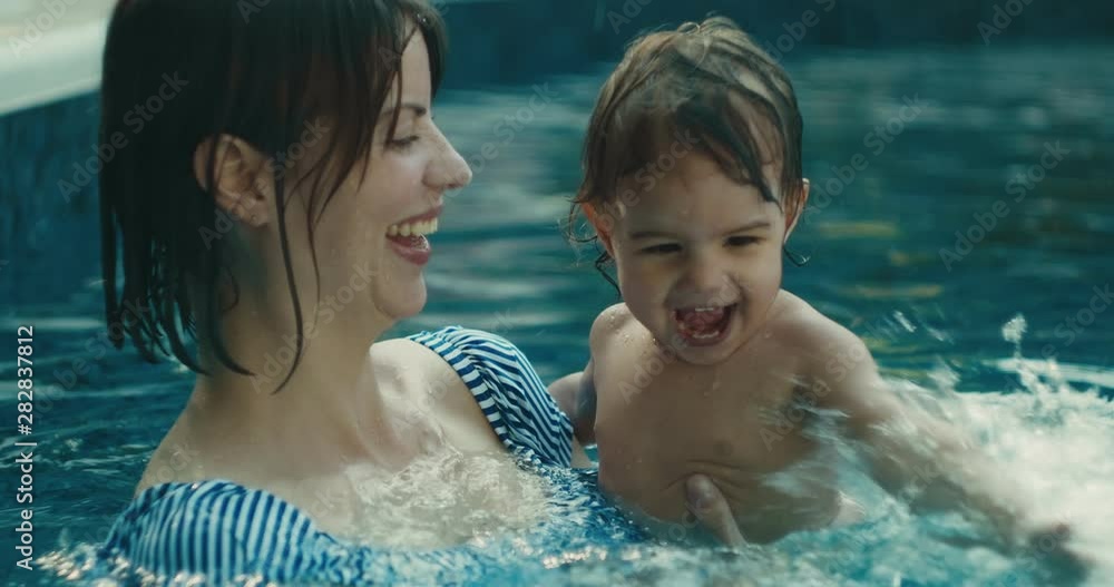Mother and baby daughter enjoying a swim. 4K lifestyle footage. Shot on a cinema camera in RAW. Mother and baby daughter enjoying a swim. 4K lifestyle footage. Shot on a cinema camera in RAW.