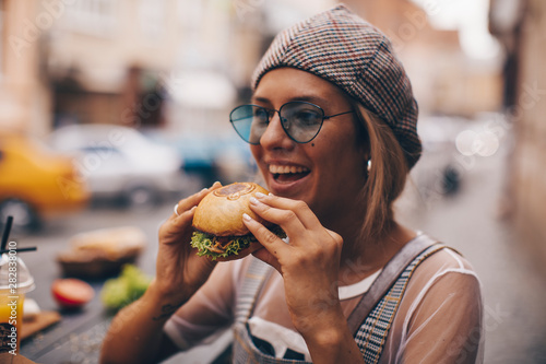 portrait of woman eating sandwich