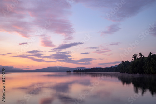 Pink and purple sunrise over Flagstaff Lake in the High Peaks region of western Maine.