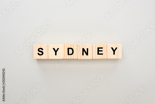 top view of wooden blocks with Sydney lettering on grey background