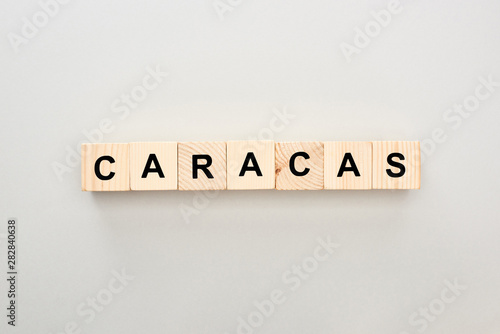 top view of wooden blocks with Caracas lettering on grey background