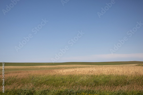 rural north dakota farm fields against a blue sky