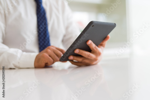 Close up of middle age business man using tablet
