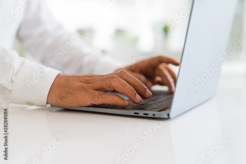 Close up of business man working using computer laptop