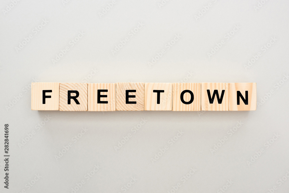 top view of wooden blocks with Freetown lettering on grey background top view of wooden blocks with Freetown lettering on grey background