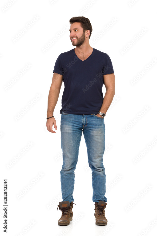 Handsome Man Is Standing With Hand In Pocket, Looking Away And Smiling Handsome Man Is Standing With Hand In Pocket, Looking Away And Smiling