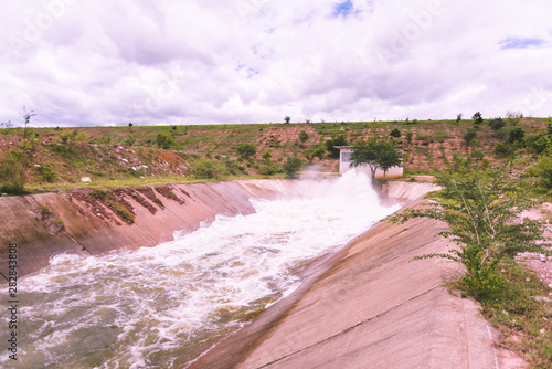 motion blur of waterfall from overflow of dam on rainy season