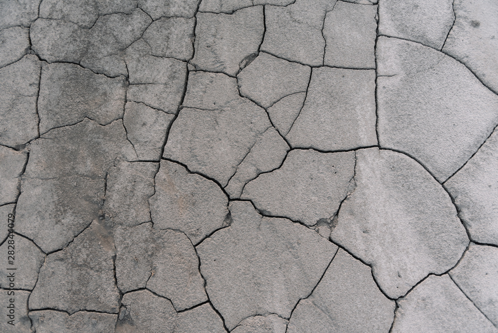Grey cracked earth ground from drought disaster cause from weather change. The global warming and greenhouse effect cause of agricultural production is reduced. Grey cracked earth ground from drought disaster cause from weather change. The global warming and greenhouse effect cause of agricultural production is reduced.