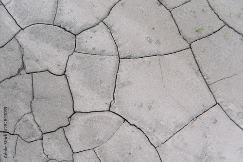 Grey cracked earth ground from drought disaster cause from weather change. The global warming and greenhouse effect cause of agricultural production is reduced.