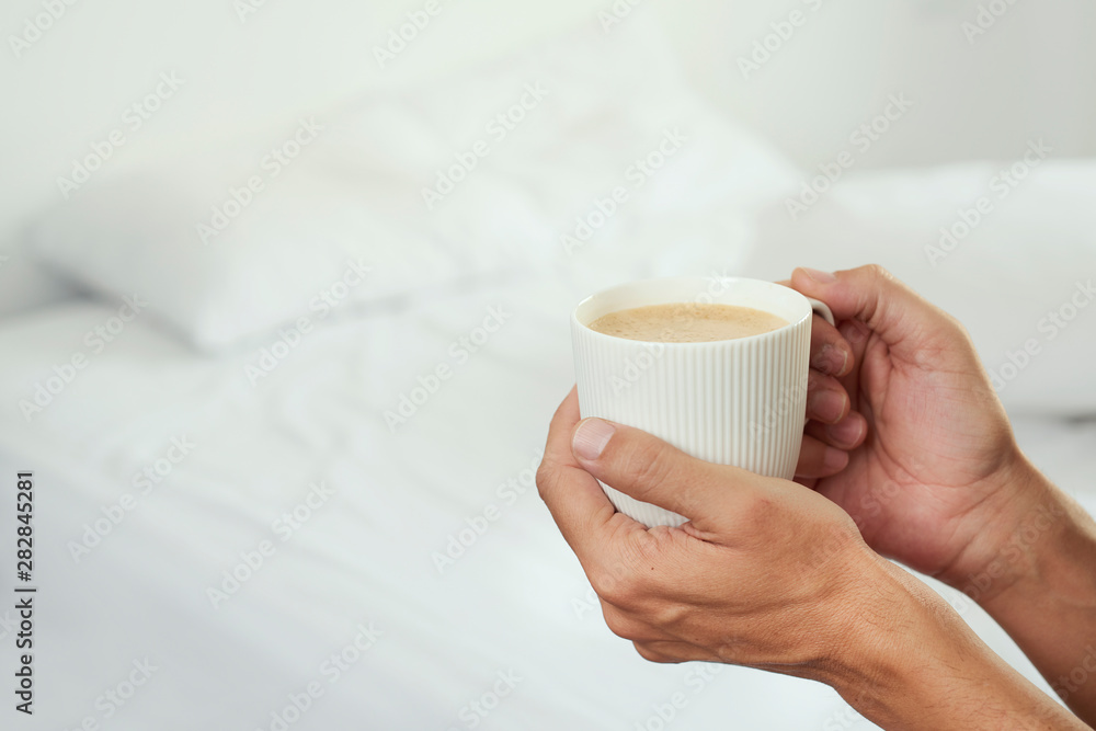 man having a coffee in a bedroom man having a coffee in a bedroom