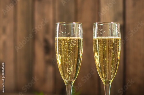 champagne in transparent glasses and a bottle (New Year's atmosphere, Christmas) of happy holidays! top food background. copy space