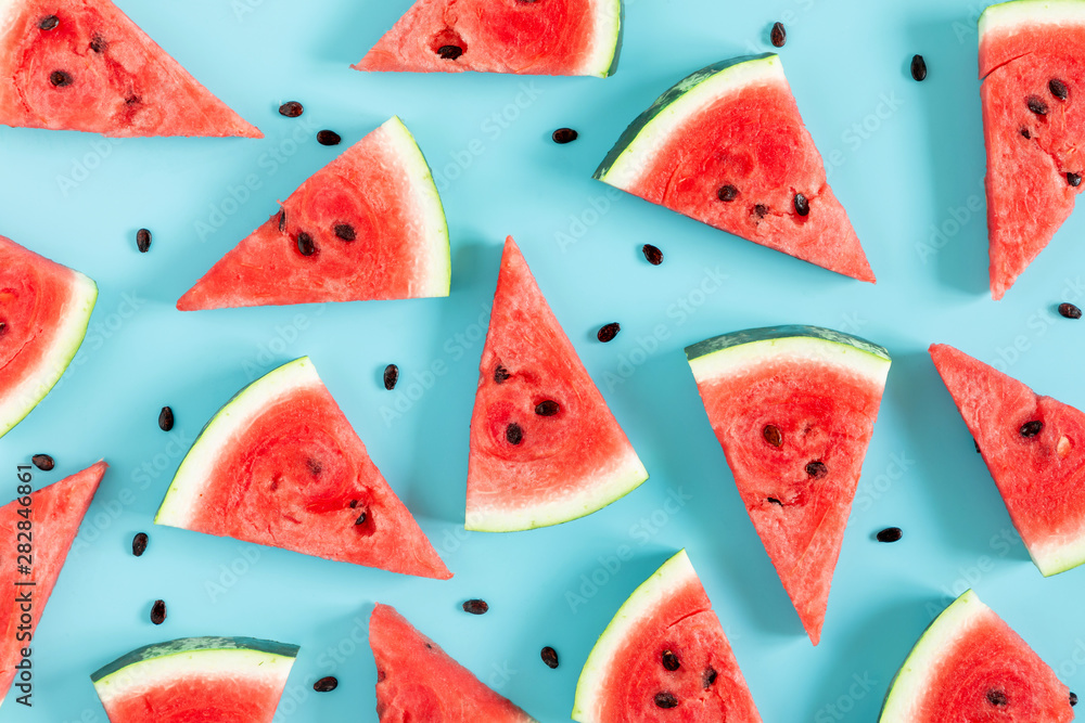 Sliced watermelon on light blue background. Watermelon slice. Summer concept. Flat lay, top view, copy space Sliced watermelon on light blue background. Watermelon slice. Summer concept. Flat lay, top view, copy space