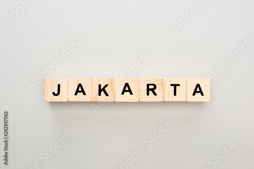 top view of wooden blocks with Jakarta lettering on grey background