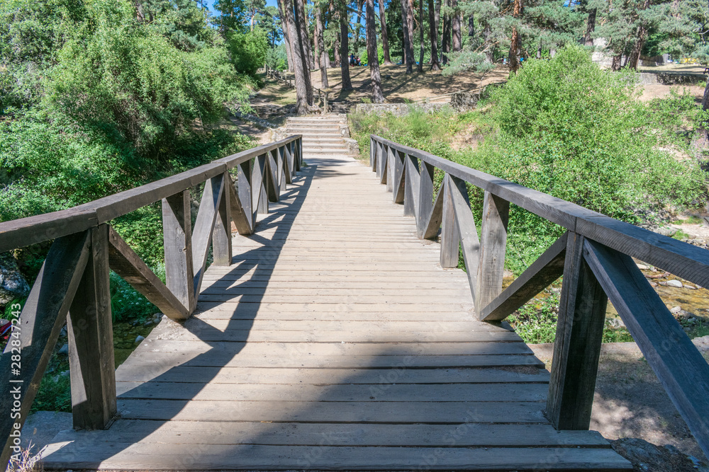 wooden bridge over mountain stream