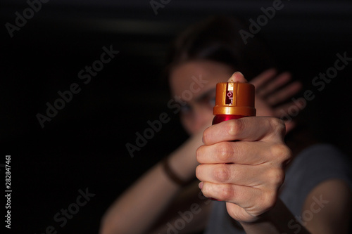 Pepper spray. Spray in the girl’s hand. Self defense concept