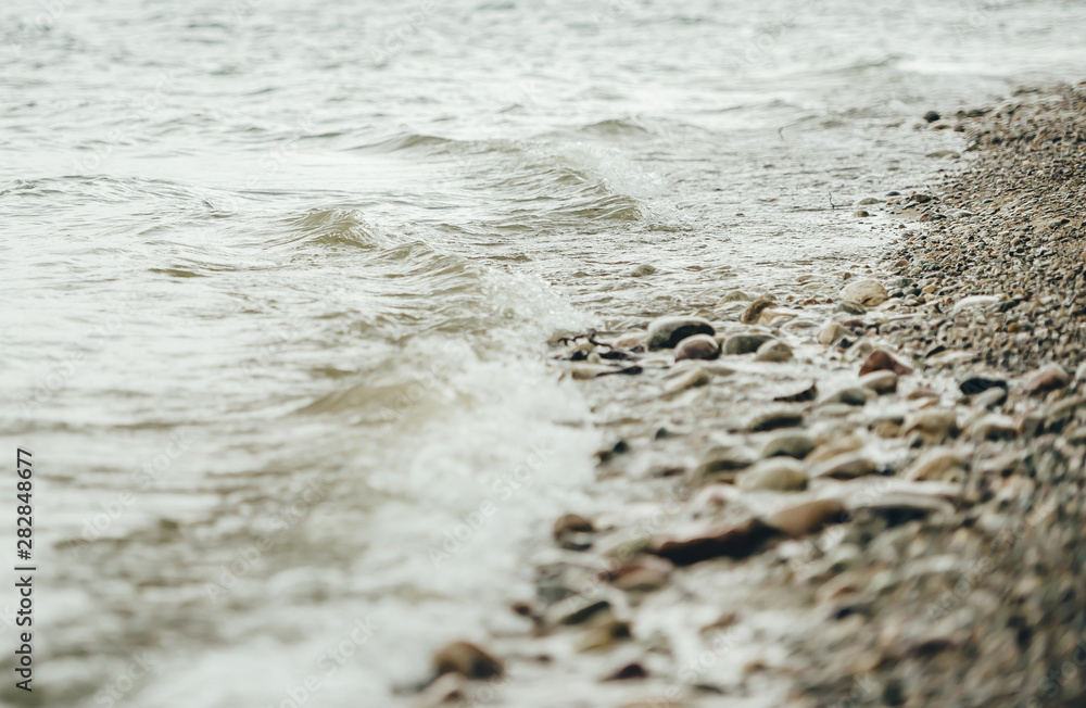 Pebble stones on sandy river bank. Closeup Pebble stones on sandy river bank. Closeup