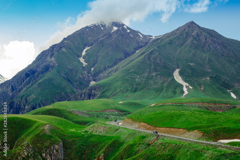 Beautiful mountain landscape. Green grass. Clouds in the sky. Travel concept. Beautiful mountain landscape. Green grass. Clouds in the sky. Travel concept.