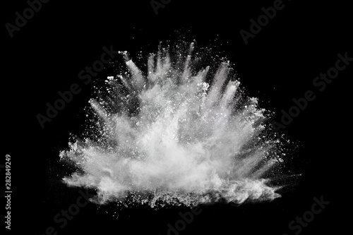 Foto White powder explosion on black background