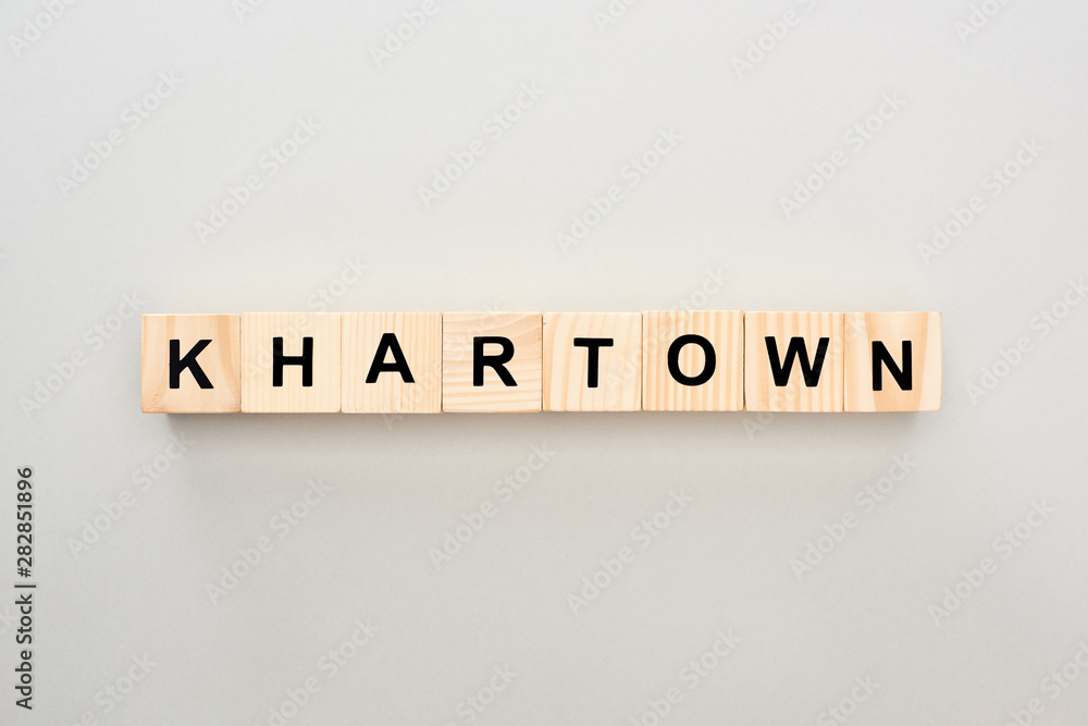 top view of wooden blocks with Khartown lettering on grey background top view of wooden blocks with Khartown lettering on grey background