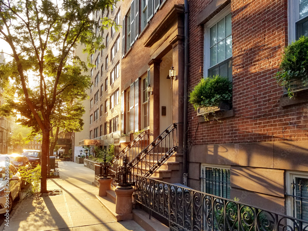 Old brownstone buildings along a quiet neighborhood street in Greenwich Village, New York City