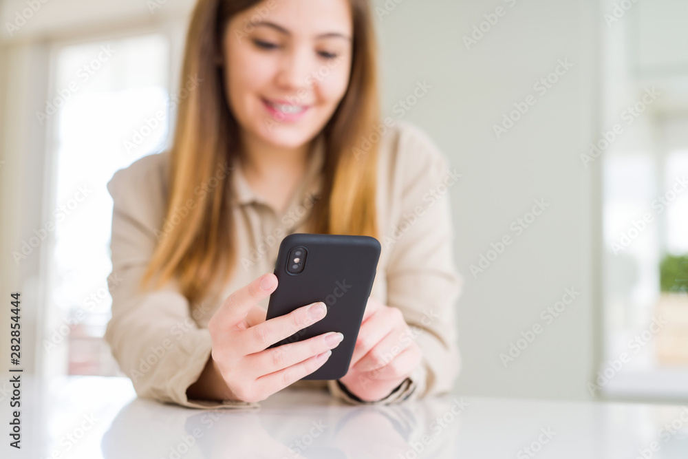 Close up of woman using smartphone and smiling confident Close up of woman using smartphone and smiling confident
