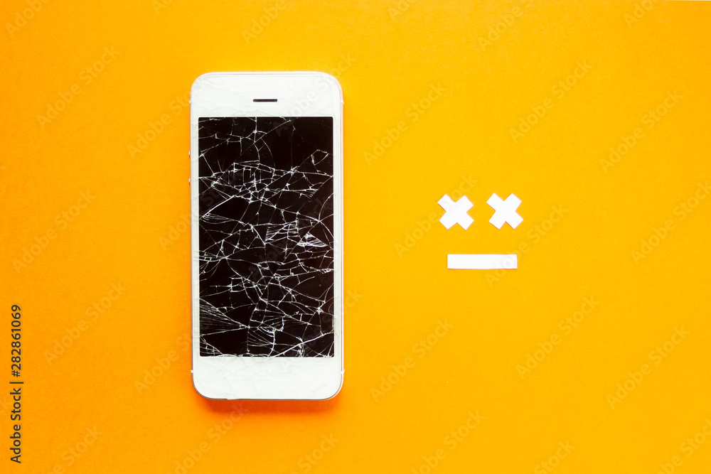 Broken smartphone with cracked destroyed screen on orange background with  sad smile. Broken phone service, recovery and repair concept, symbol top  view. Stock-Foto | Adobe Stock