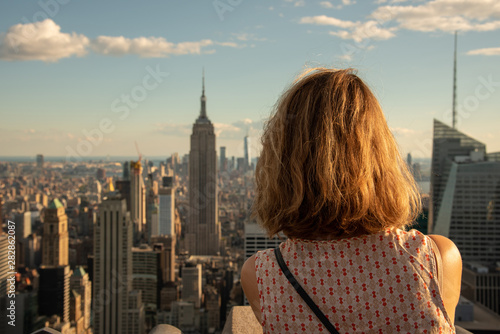 Blonde tourist taking a picture of the Empire State photo