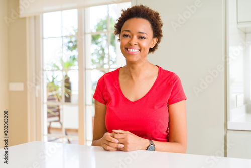 Young beautiful african american woman at home with a happy and cool smile on face. Lucky person.