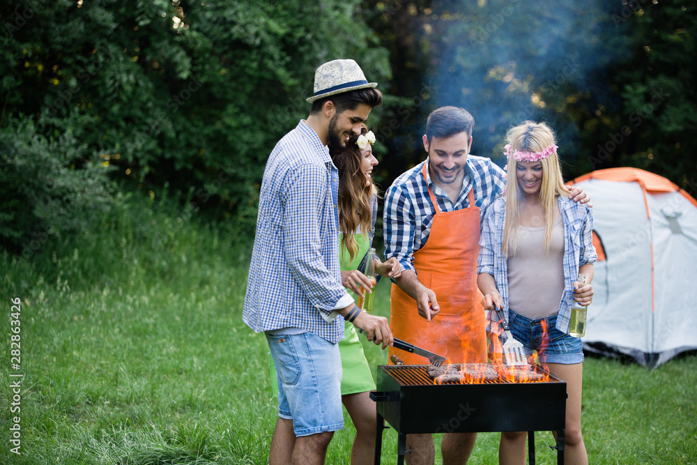 Friends having a barbecue party in nature Friends having a barbecue party in nature