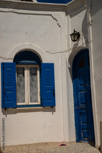 Door and window in Firostefani, Santorini island, Greece. Vintage feature of Greek houses. © Roza_Sean