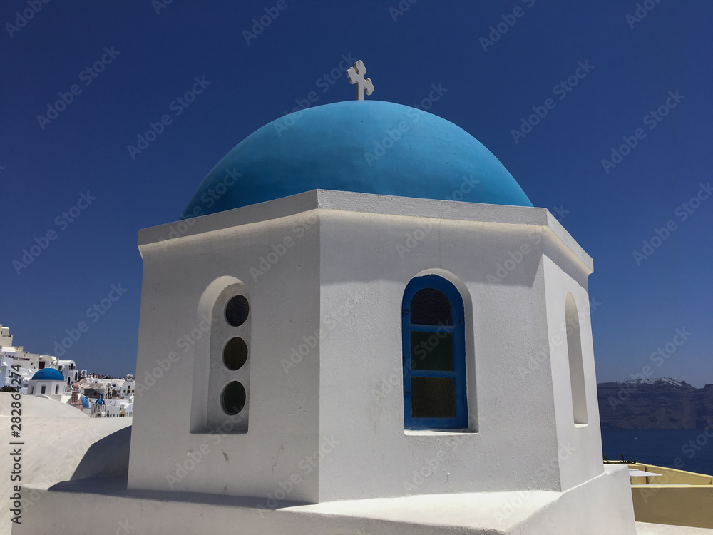 Characteristic blue dome of a church in Oia in Santorini Greek island. Traditional blue and white color of the church.