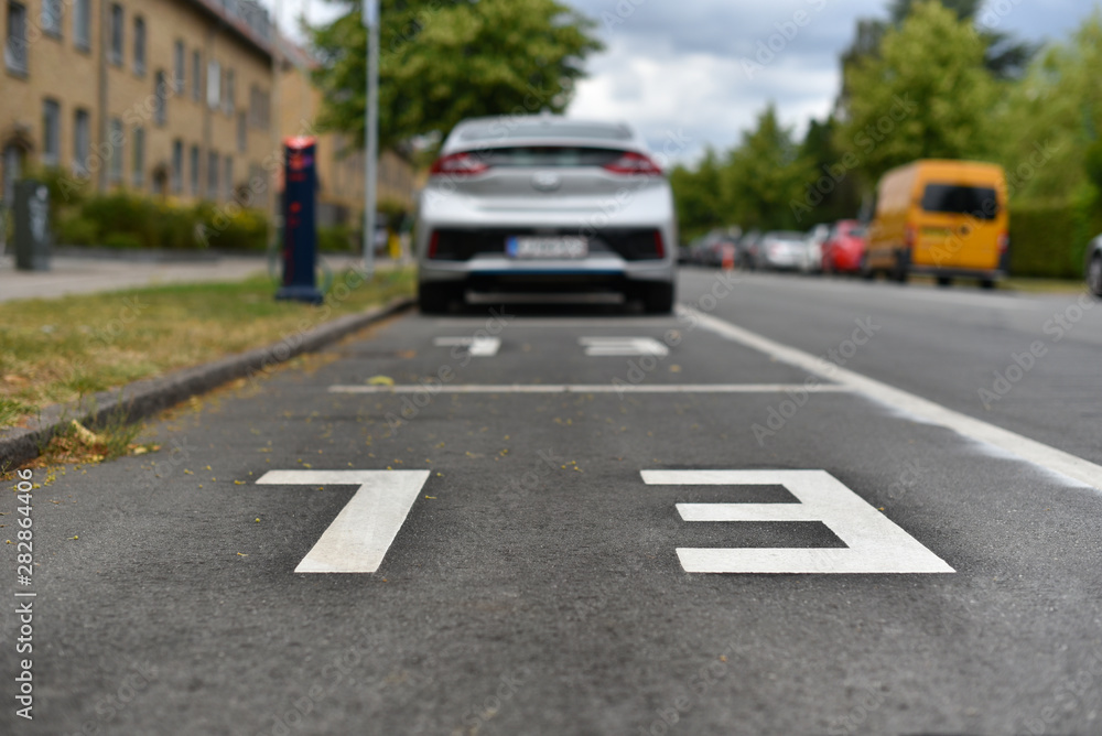 parking places with chargers for electric cars with inscription of abbreviature EL - electric car on asphalt parking places with chargers for electric cars with inscription of abbreviature EL - electric car on asphalt