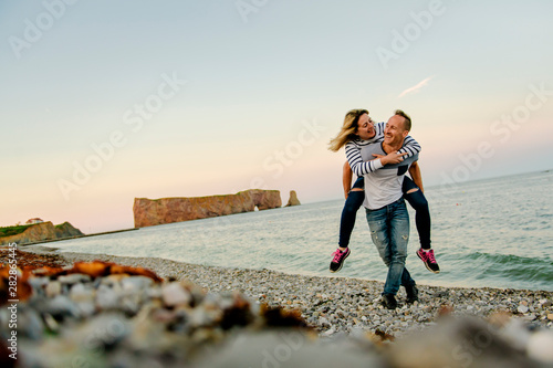 tourist couple enjoying Perce Rock view from Gaspe in Quebec photo
